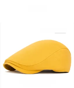 Detail view of yellow cotton beret showing fine stitching and adjustable back buckle