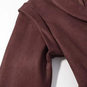 Close-up of premium burgundy faux suede jacket showing detailed stitching and fabric texture