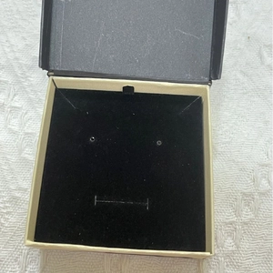 Square beige jewelry box with black velvet interior for rings and earrings