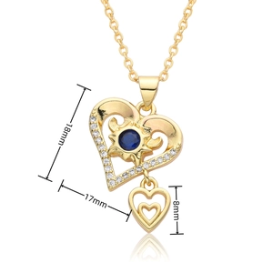 Detailed size view of a 18k gold heart necklace with a blue gemstone and sunburst pattern