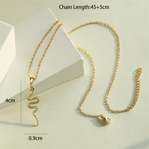18K gold plated snake pendant necklace with pavé cubic zirconia on beige background