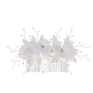 Detail view of bridal hair comb with silk flowers, crystal beads and pearls