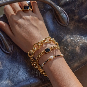 Stacked vintage 18K gold-plated chunky cross chains with black gemstones and pearls