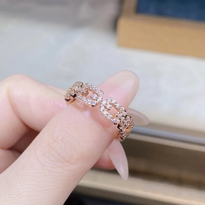 Macro shot of rose gold chain link ring featuring pavé set white cubic zirconia stones
