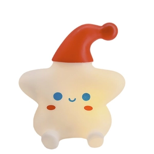 Star-shaped LED night light with red sleep hat emitting soft warm glow on white background