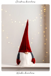 Christmas felt gnome with red hat and white beard in a cozy holiday indoor setting