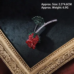 Detailed macro view of baroque rose brooch with red crystals and dimensions 2.5x4.6cm