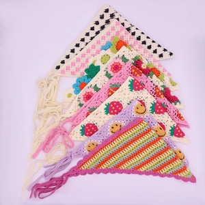 Detailed texture of handmade crochet bandanas with strawberry and floral knit patterns