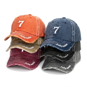 Detail of vintage washed baseball caps with number 7 embroidery and distressed brim details