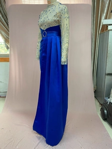 Detail of royal blue evening dress with sequin bodice and silver glitter texture