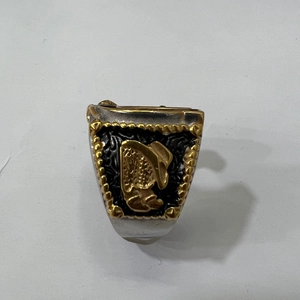 Close-up of vintage horseshoe ring with gold cowboy hat and boots relief details