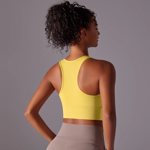 Detail view of the yellow racerback sports bra showing ergonomic back support and high elasticity