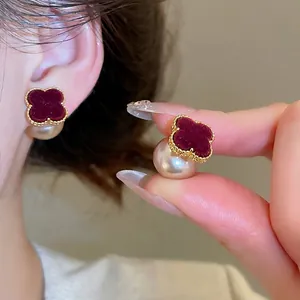 Retro velvet clover stud earrings with lustrous white pearls and golden trim detail