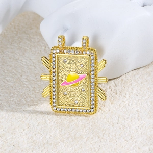 Detail of a gold rectangular pendant featuring a colorful enamel Saturn design and gems
