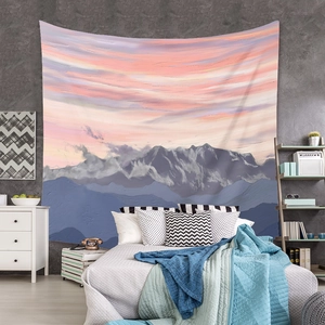 Detail view of snowy mountain tapestry hanging on a textured wall above a cozy bed