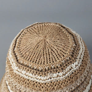 Macro shot of radial knit texture and brown-beige striped pattern on top of sun hat