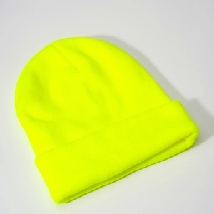 Close-up of neon yellow knit beanie showing high-quality acrylic ribbed texture and cuff