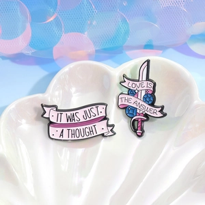 Pink enamel sword and ribbon pins with inspirational quotes on shell tray