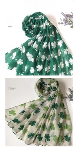 Detail of Irish Saint Patrick's Day scarves with clover patterns in green and cream white