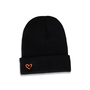 Close-up of black knitted beanie featuring orange heart embroidery and ribbed texture