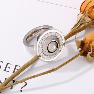 Detail view of silver stainless steel ring with zircon accents and center polished bead