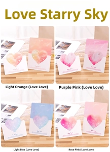 Detail view of heart-shaped greeting cards featuring starry gradient designs in four colors