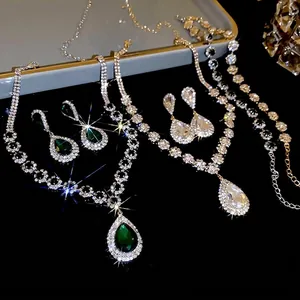 Luxury waterdrop jewelry set featuring emerald and diamond necklaces with matching earrings