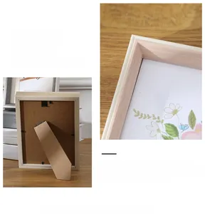 Detail of a Nordic light pink wooden photo frame with back support on a minimalist desk