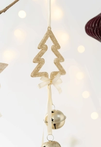 Detail of hollow Christmas tree ornament with golden bell and cream ribbon bow