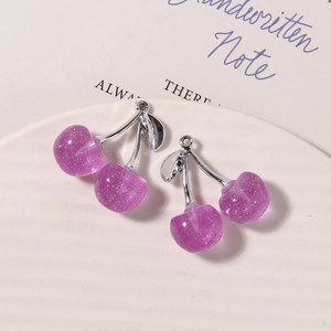 Macro detail of purple translucent glitter cherry charms with silver metal stems for DIY