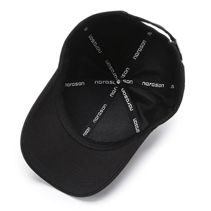 Inside view of black baseball cap showing branded narason seam tape and cotton texture