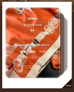 Detail of orange knight horse scarf showing soft cashmere-like texture and horse harness print