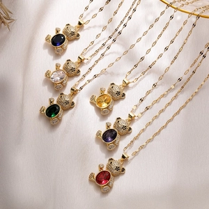 Detailed view of six gold-plated necklaces featuring colorful zircon paved bear pendants