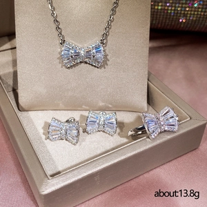 Elegant silver bow jewelry set with necklace earrings and ring in a gift box