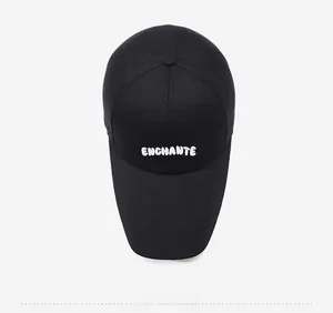 Top down view of black cotton baseball cap featuring white ENCHANTE letter embroidery
