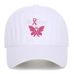 Close-up of pink Believe embroidery and ribbon butterfly on white cotton baseball cap