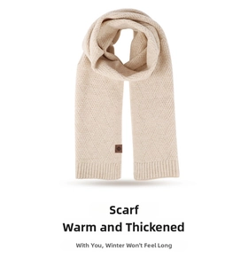 Close-up of cream knit scarf with diamond texture and brown leather snowflake patch