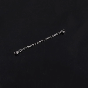 Polished silver stainless steel extender chain with dual lobster clasps on black background
