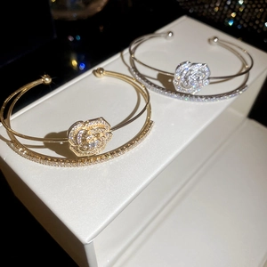 Detailed macro view of the double-layered flower bangle with pavé-set cubic zirconia stones
