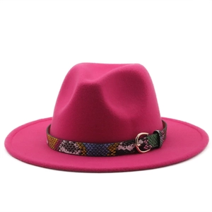 Detail of rose pink fedora hat with colorful snakeskin band and gold buckle detail