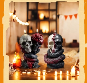 Detailed view of Gothic skull candles with entwined snakes and red roses for Halloween