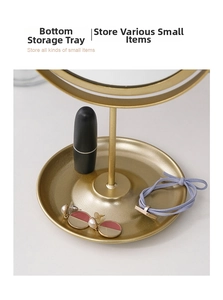 Close-up of golden metal vanity mirror base tray storing lipsticks and jewelry