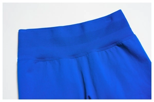 Detailed close-up of seamless ribbed high waistband on royal blue yoga shorts