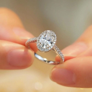 Elegant silver engagement ring with oval clear zircon and pavé diamonds setting