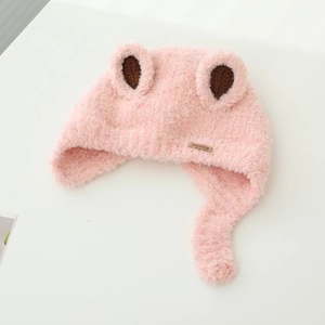 Detail of pink plush baby winter hat with animal ears and FASHION metal label