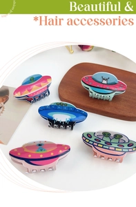 Detailed close-up of 5-piece alien and UFO themed acrylic hair claws set in vibrant colors