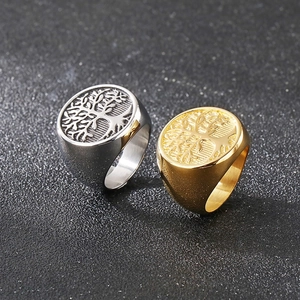 Macro detail of tree of life engraving on vintage gold and silver punk rings