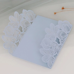 Detail of laser-cut wedding invitation cover with light blue floral rose hollow pattern