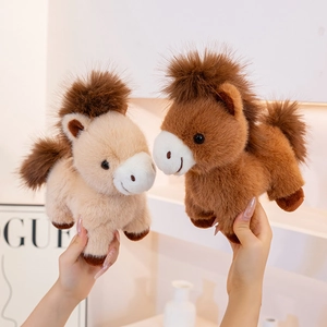 Set of two cute plush pony dolls with fluffy manes and tails in beige and dark brown