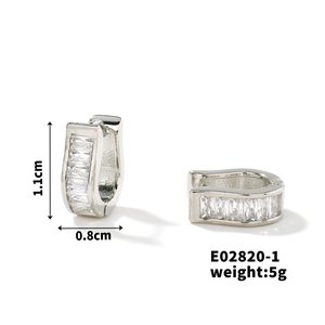 Detailed macro view of U-shaped silver earrings with sparkling cubic zirconia settings